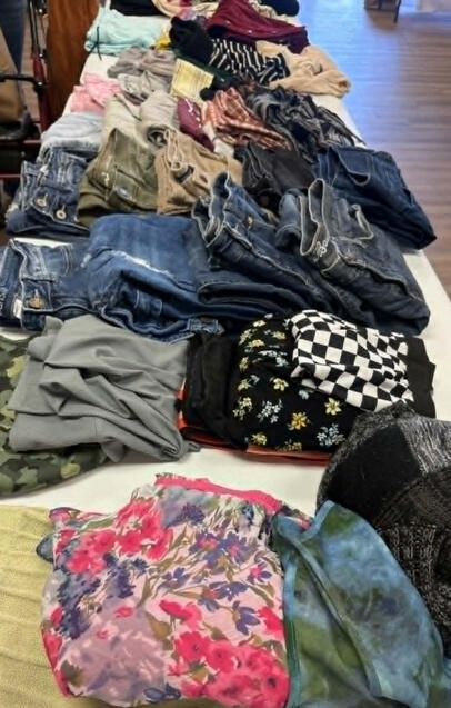 Tables of clothes at our Clothing Swap & Craft Social