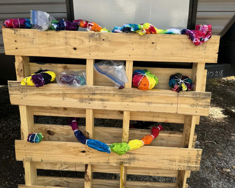 Volunteers tie dye shirts to wear for Pridefest